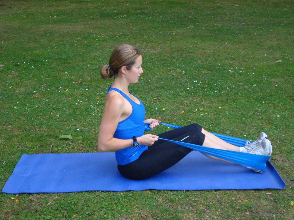 A seated row with a resistance band is a good way for beginners to practice the pull pattern, a fundamental compound movement.