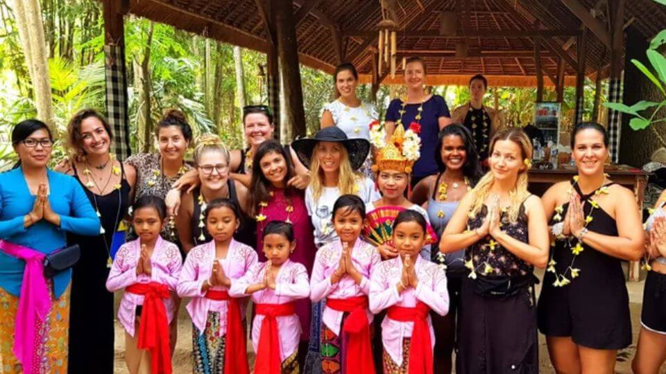 A retreat group at FireFly Retreat in Ubud pictured with local people.