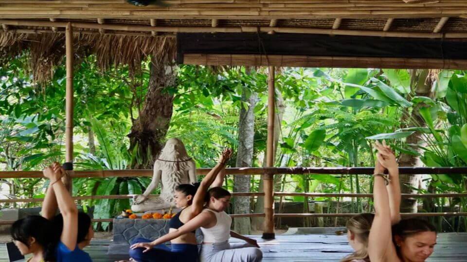 People practice yoga in the yoga shala at Surf and Yoga Bali.