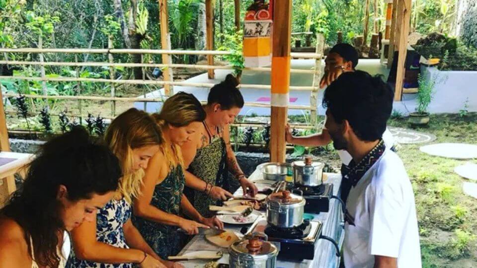 Retreat participants learning to prepare traditional food at FireFly Retreat in Ubud.