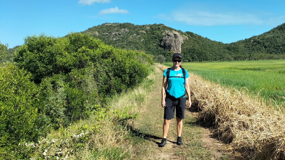 Elly stops for a photo in the Townsville Park Common on a bright blue sunny day, while wearing the Mesa Trail II barefoot hiking shoes from Xero Shoes.