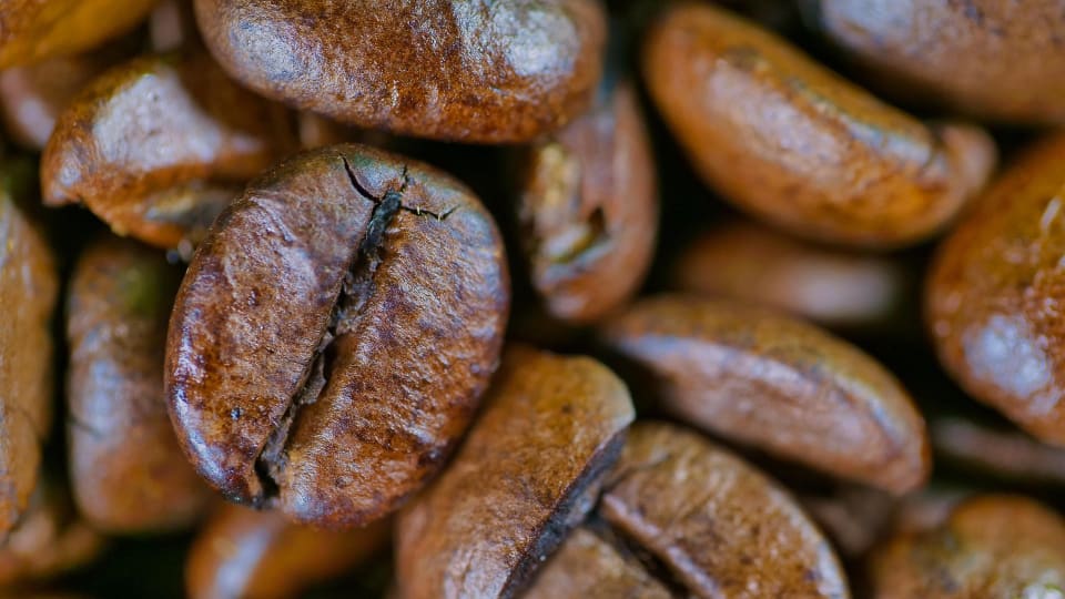 A close up view of whole coffee beans.