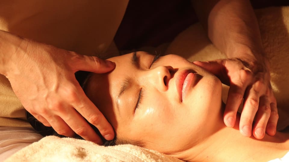 A person closes their eyes during a relaxing acupressure massage.