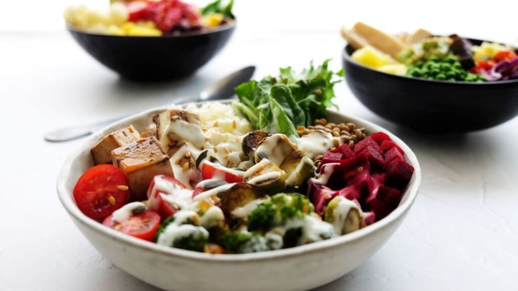 Colorful vege bowls with tofu and dressing, a delicious option for easy plant-based meals.