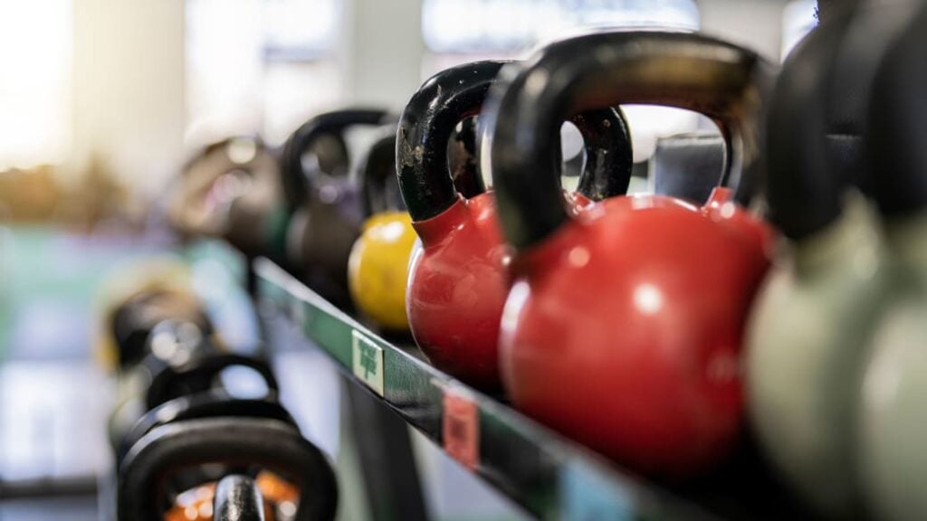 Rows of kettlebells in a rack at a gym, an excellent piece of kit for functional exercises.