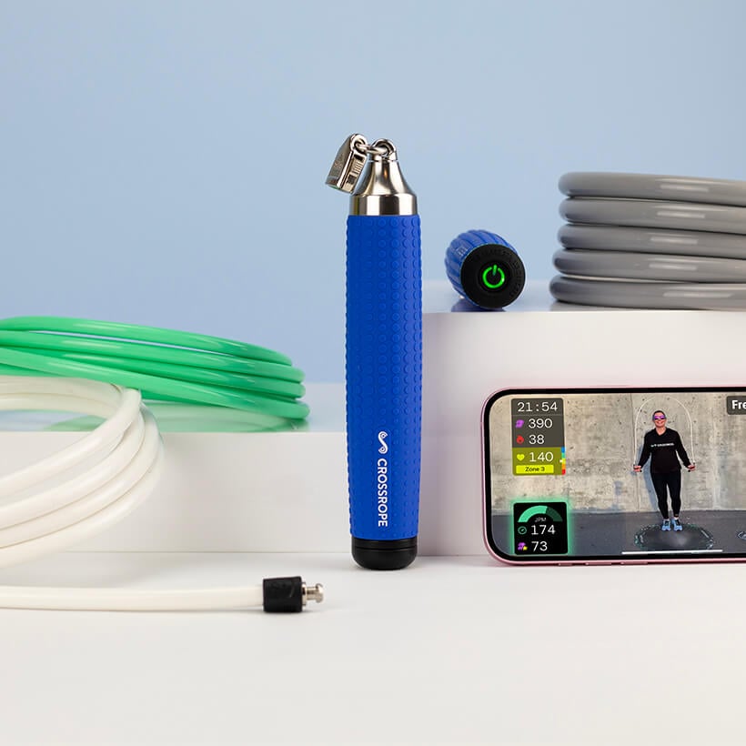 Crossrope handles, ropes and a phone showing a Crossrope workout.