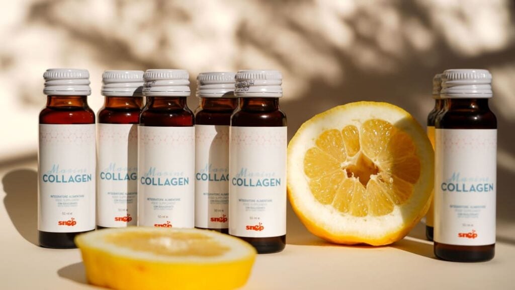 Collagen bottles and a cut up orange.