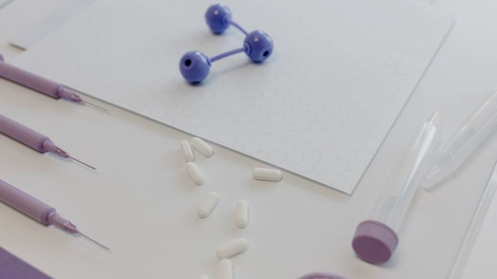 Medical tools and pills arranged on a table, showcasing a laboratory research setting.